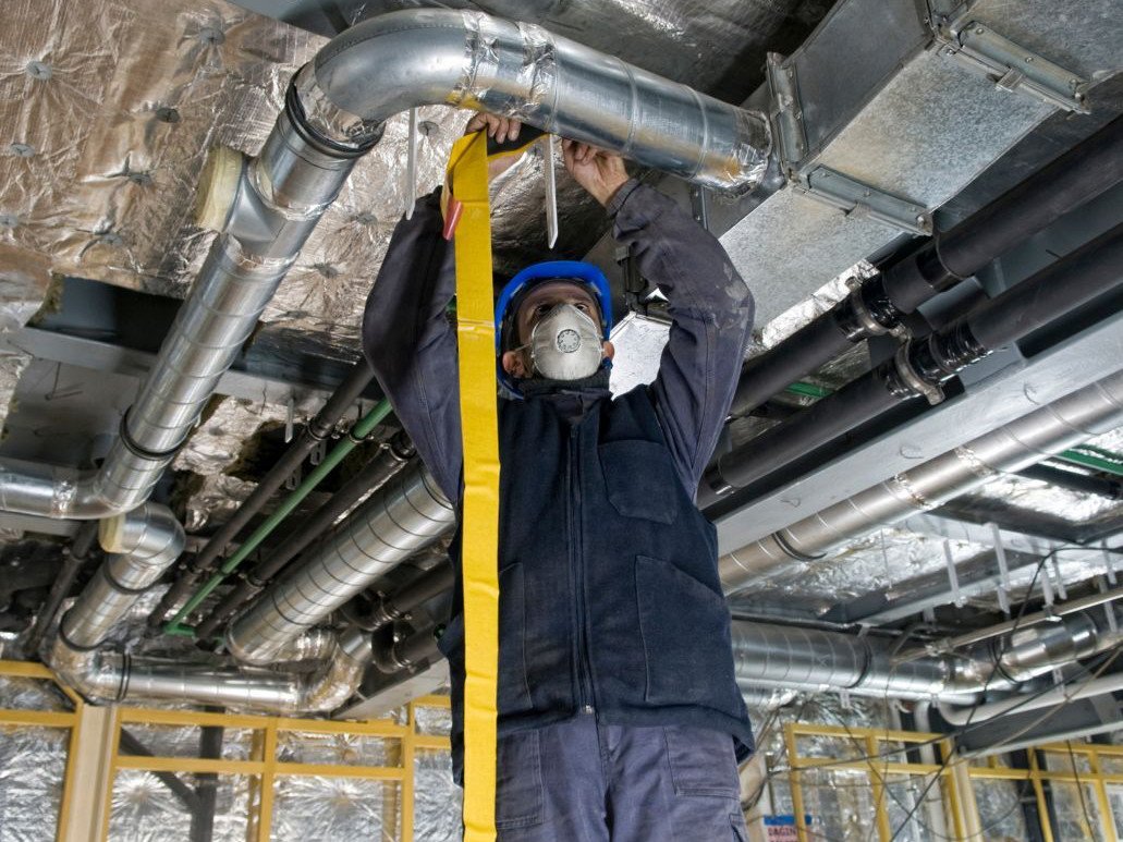 Man installing HVAC ducting